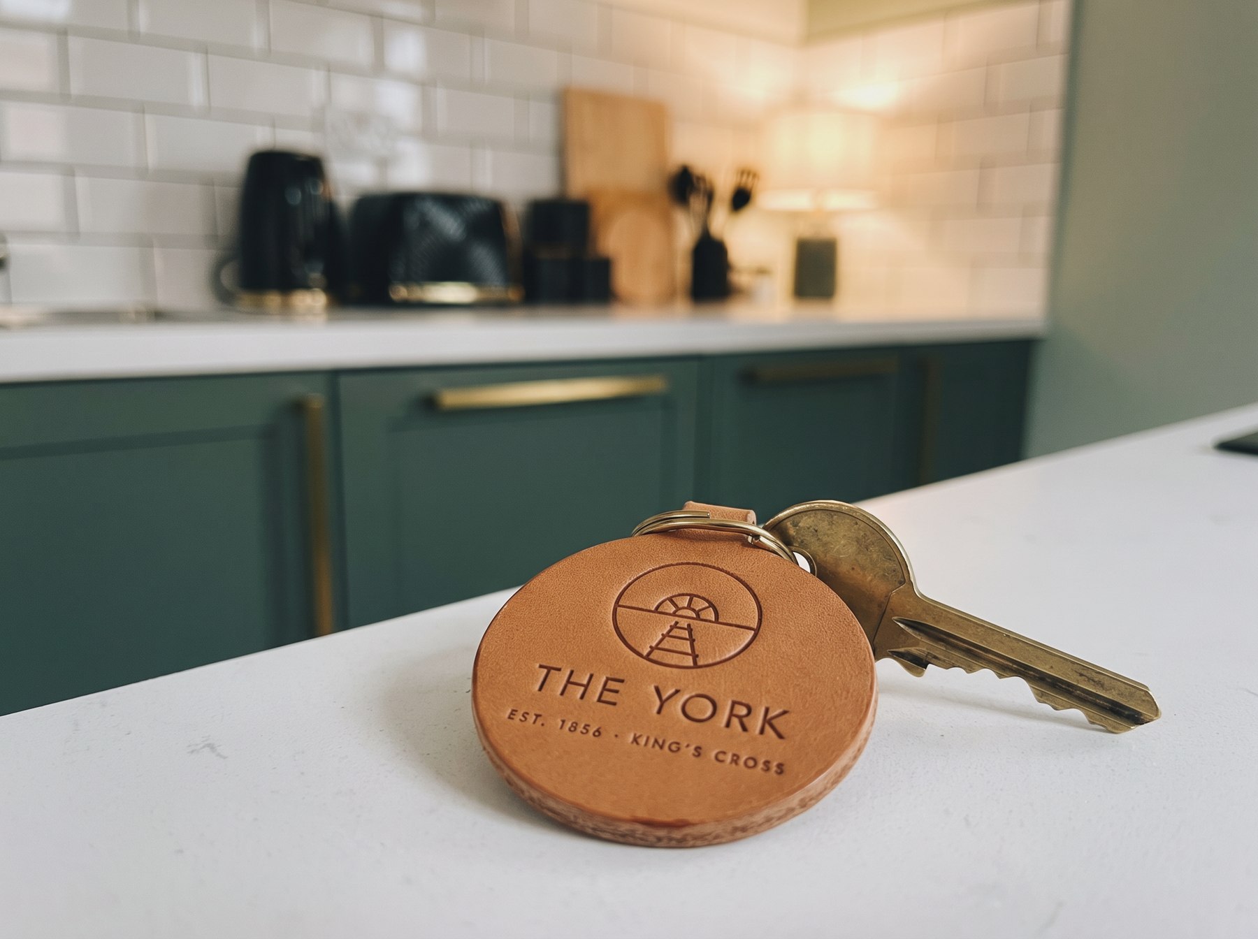 A brass key tag carrying the mark