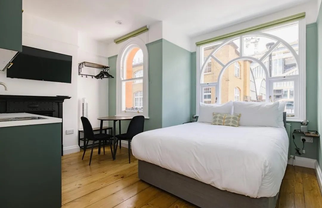 Before: the fanlight flat as listed, a white bed under two arched windows