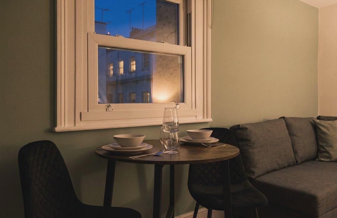 The parlour at night, lit warmly